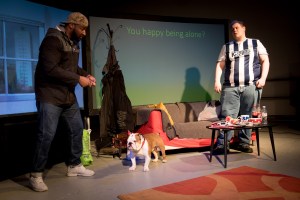 Man with cap known as Troy greets with big smile. The man with West Bromwich Albion shirt is looking confused and unhappy.