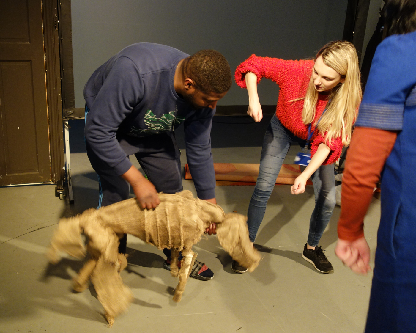  A photo of the puppet dog, held by Troy trying to get to know Bubble the dog looks cute and life like.