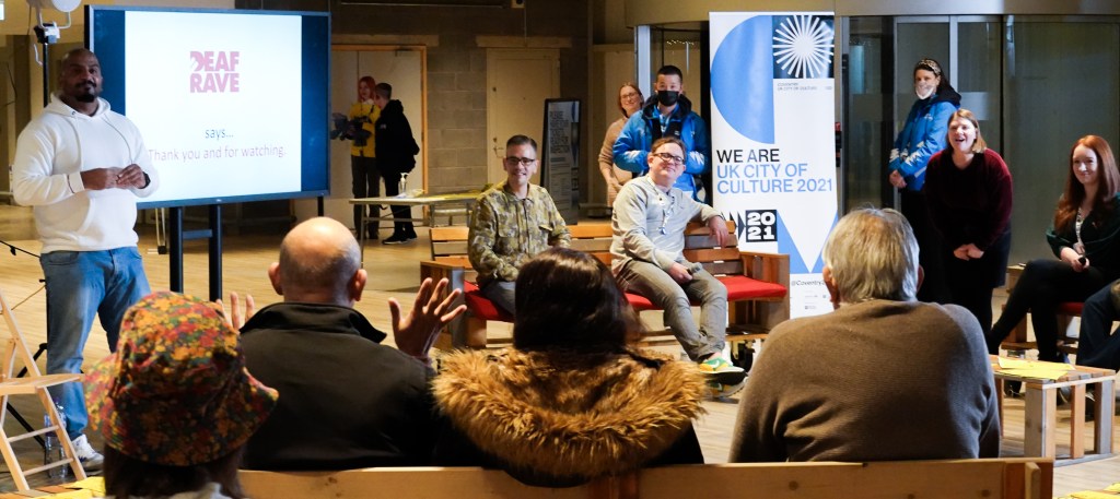 Troi Lee encourages deaf visitors to the Installation House of Feeling